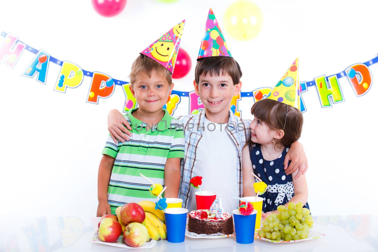 Three adorable kids having fun at birthday party