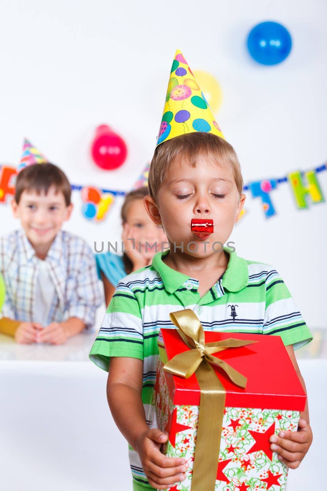 Boy with giftbox at birthday party by maxoliki