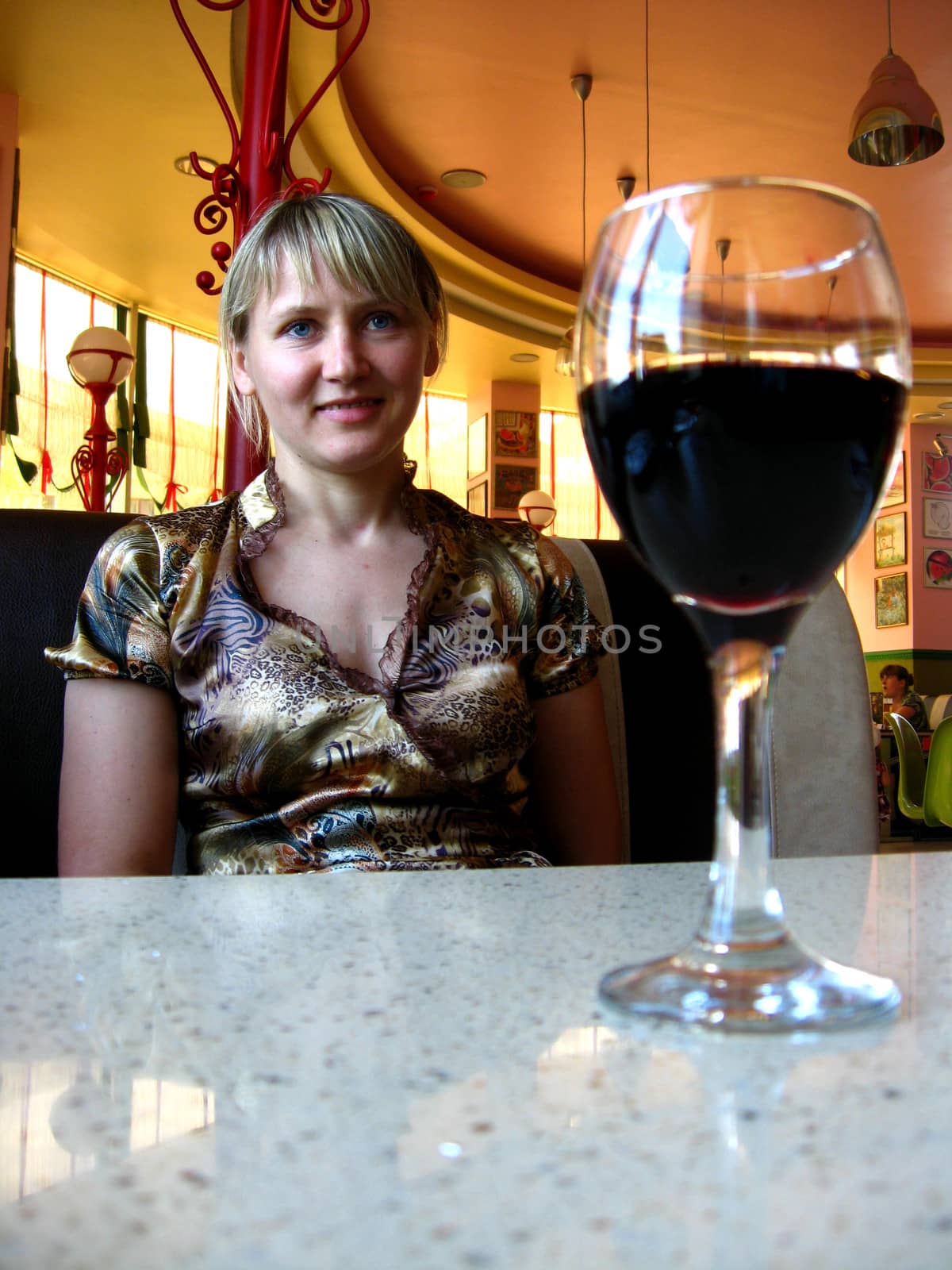 the girl with glass of red wine in restaurant
