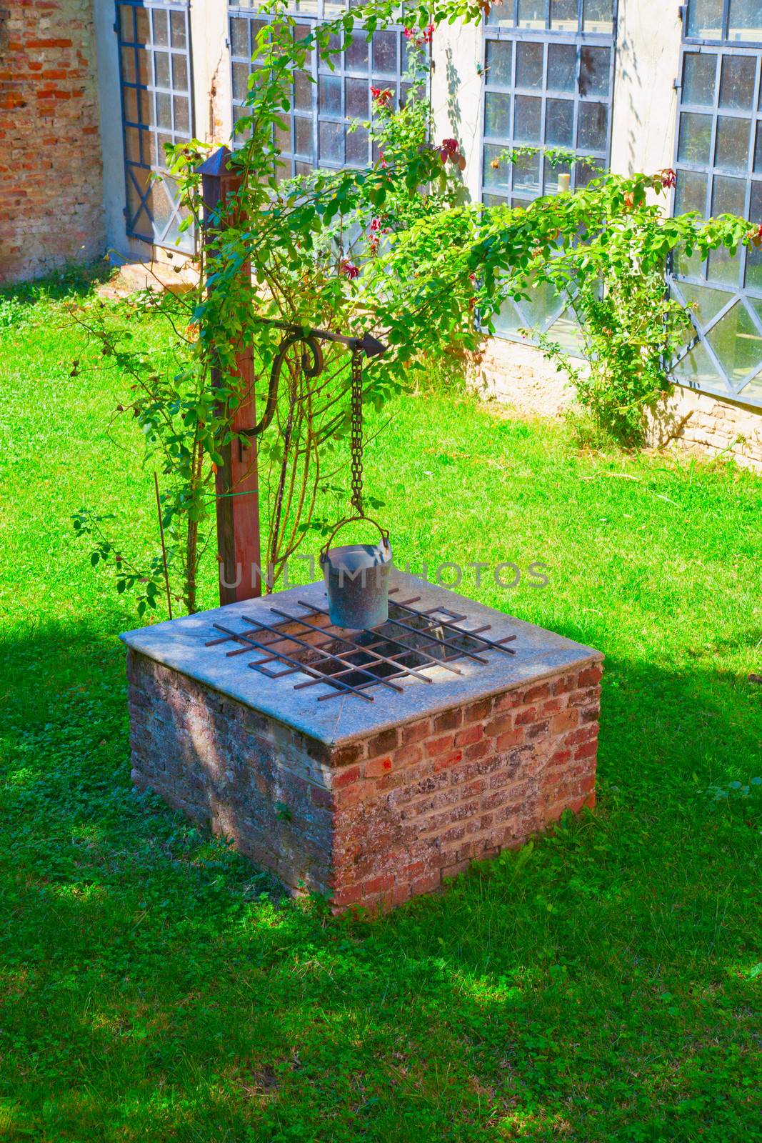 View of an old well in a grass field