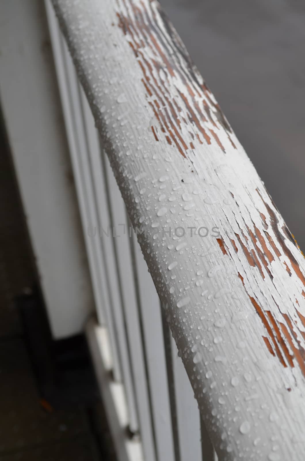 Weathered paint on wooden handrail. by bunsview