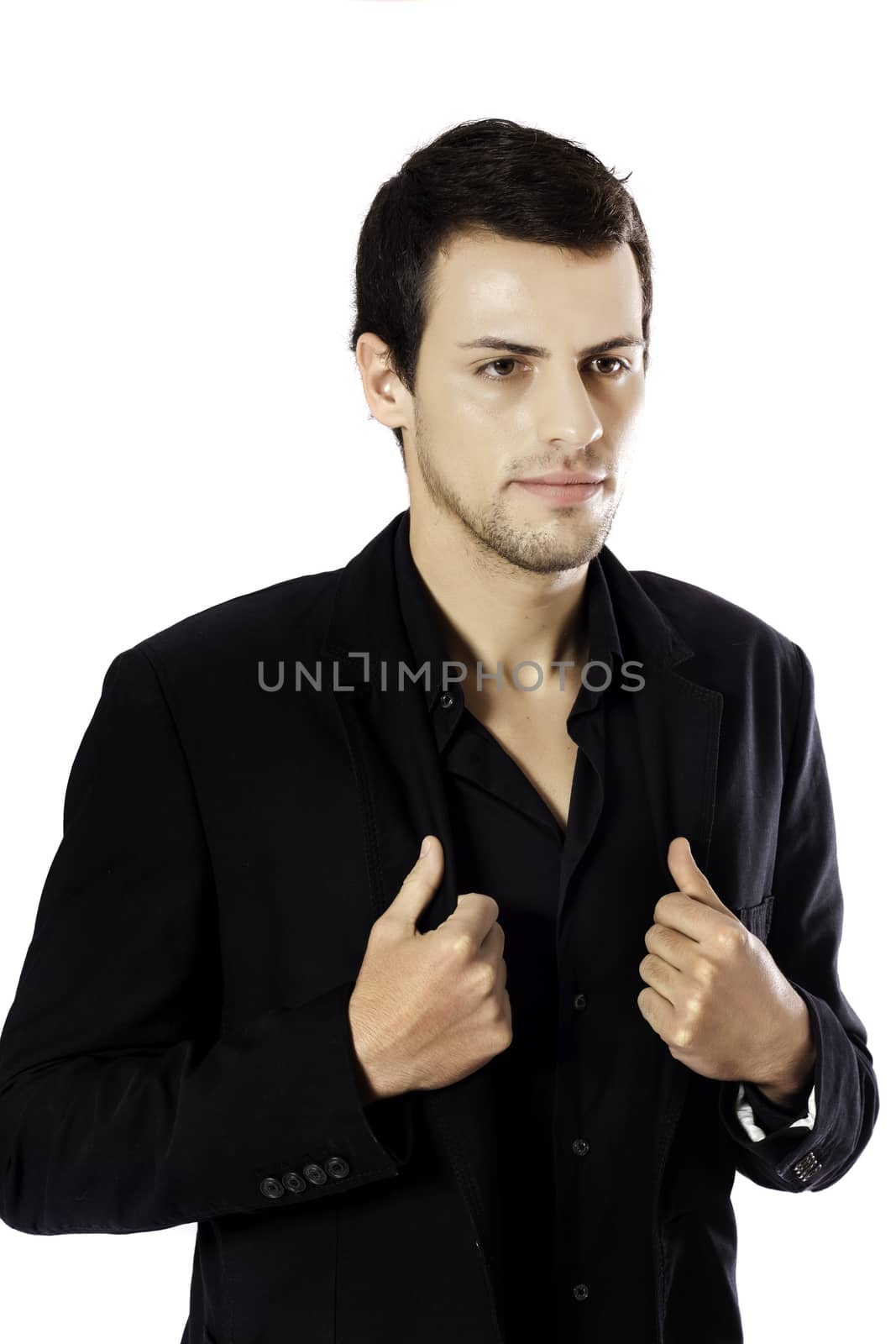 View of a young man standing against a white  background. 