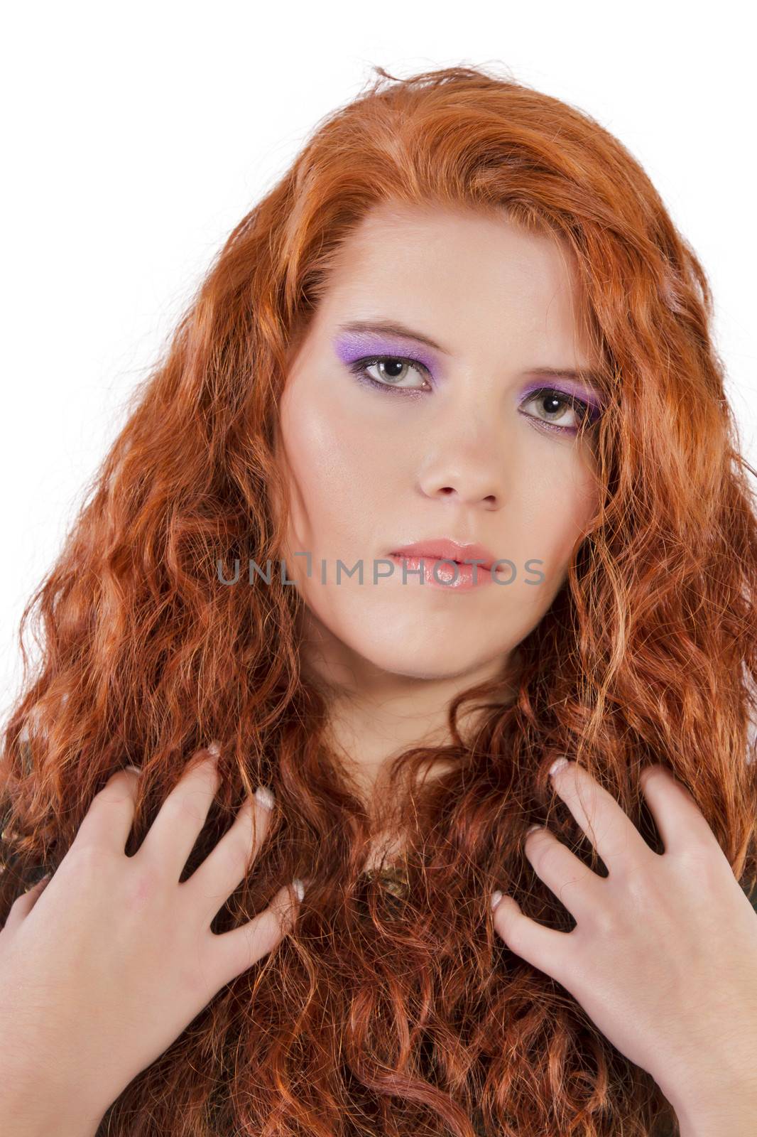 View of a beautiful young natural red hair woman isolated on a white background.