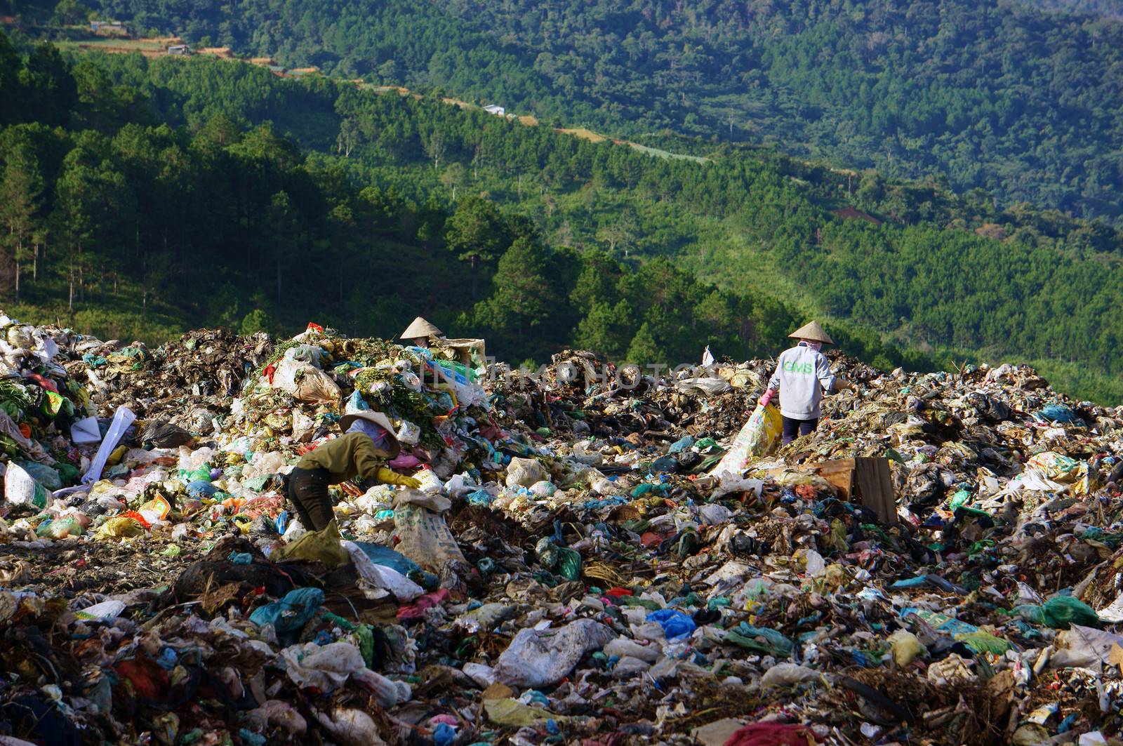 Many people make their live by pick up waste, someone pick up along street, these people concentrate at rubbish dump, they work all day here. Viet Nam- September 05, 2013