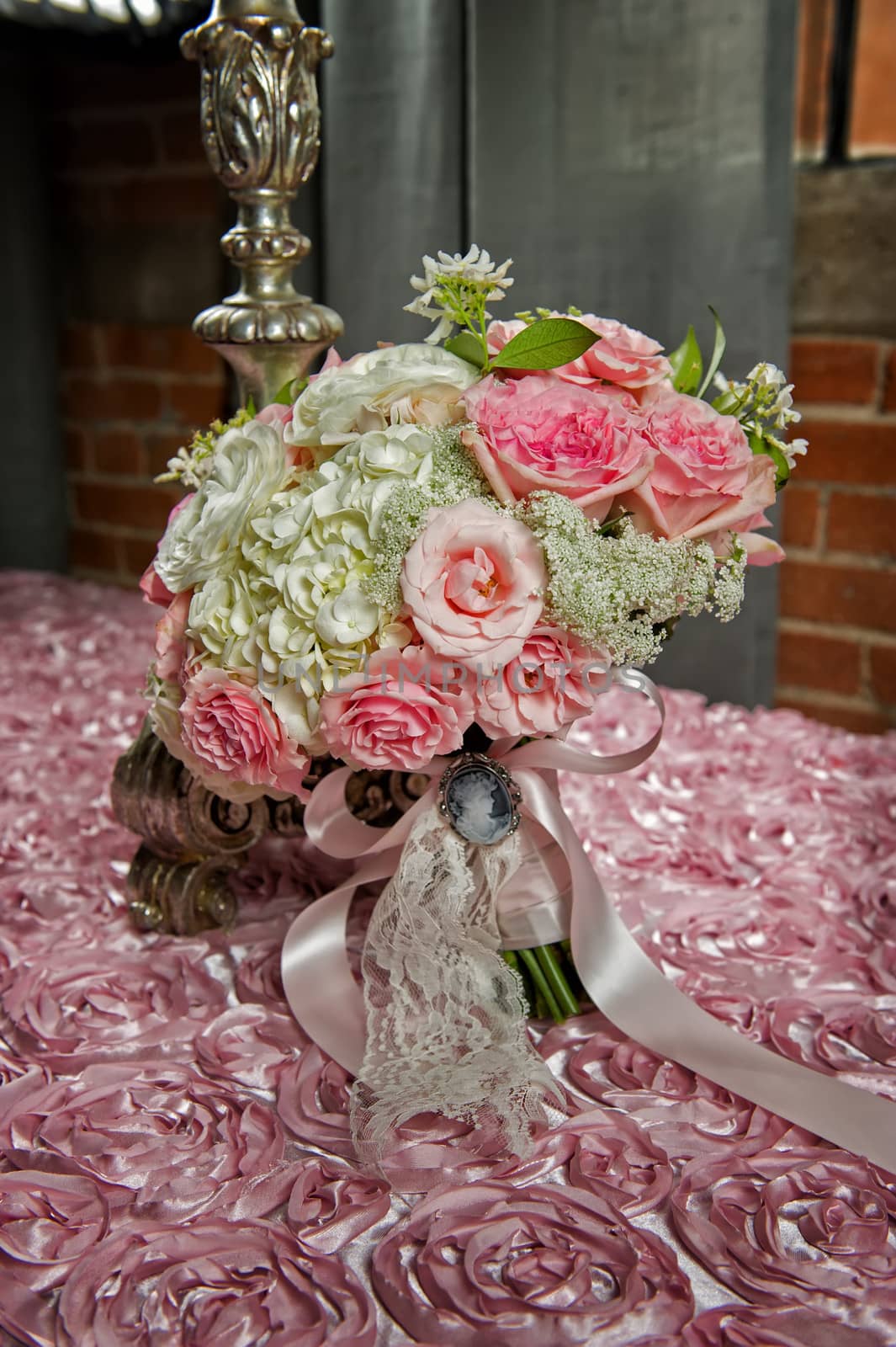 Image of a bride's wedding bouquet on a pink cloth