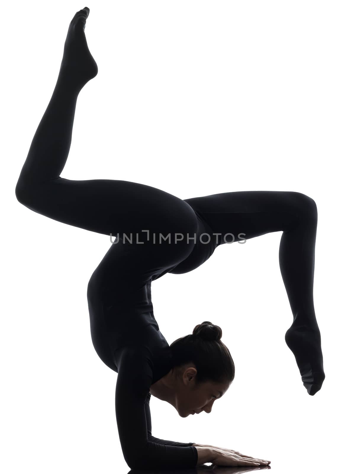 one caucasian woman contortionist practicing gymnastic yoga  in silhouette   on white background