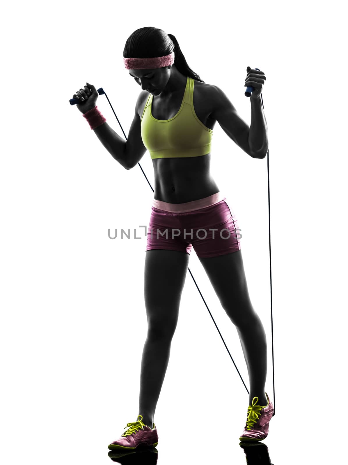 one caucasian woman exercising fitness  jumping rope  in silhouette on white background