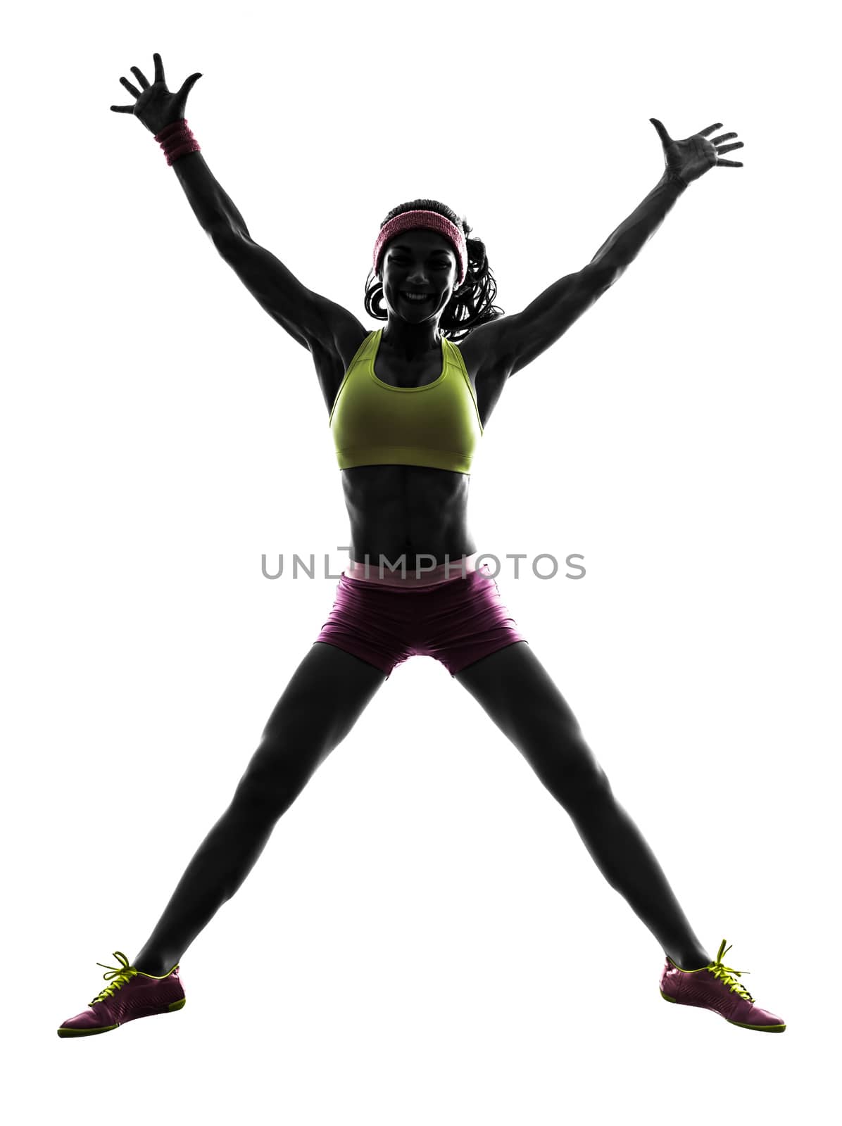 one caucasian woman jumping arms raised  in silhouette on white background