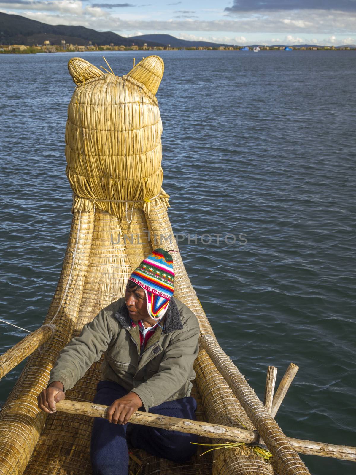 PUNO, PERU - MAR 13: Peruvian rows Totora Reed boat on Mar 13, 2011 in Lake Titicaca, Puno, Peru. These reeds have been used by various pre-Columbian South American civilizations to build reed boats.