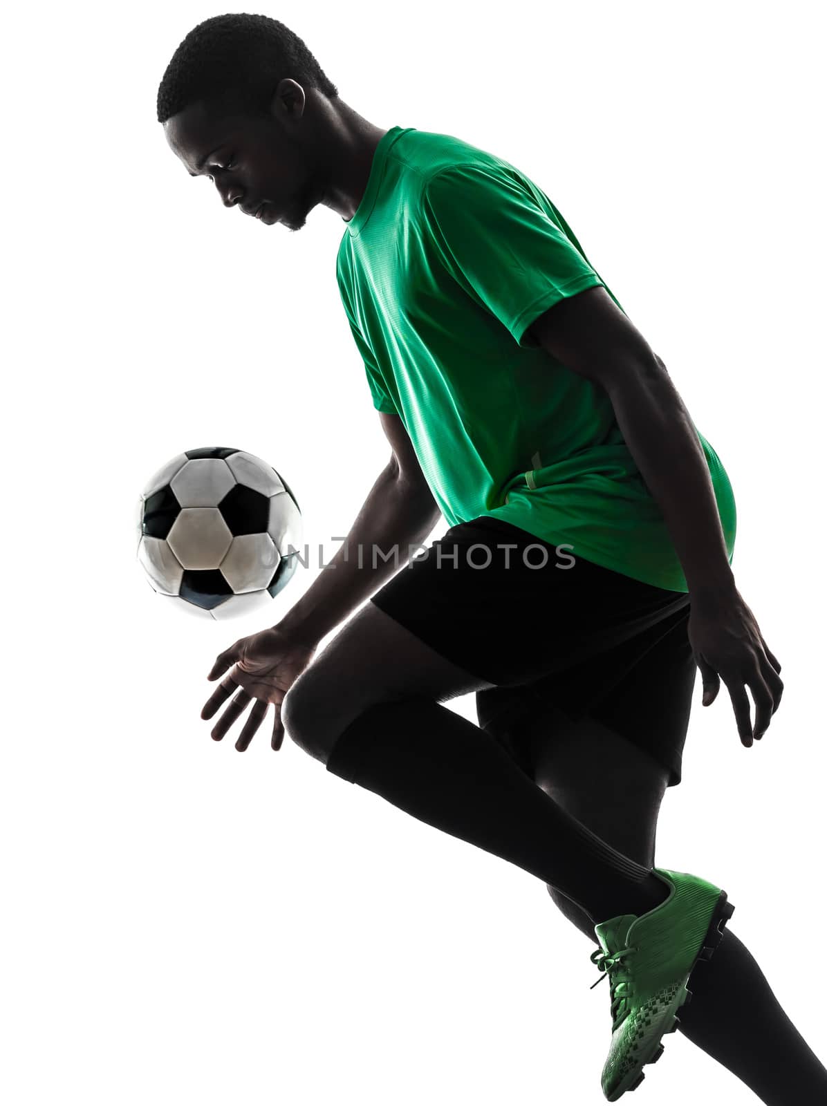one african man soccer player green jersey juggling in silhouette  on white background