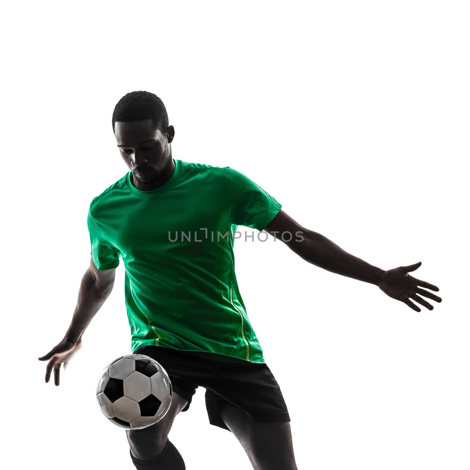 one african man soccer player green jersey juggling in silhouette  on white background