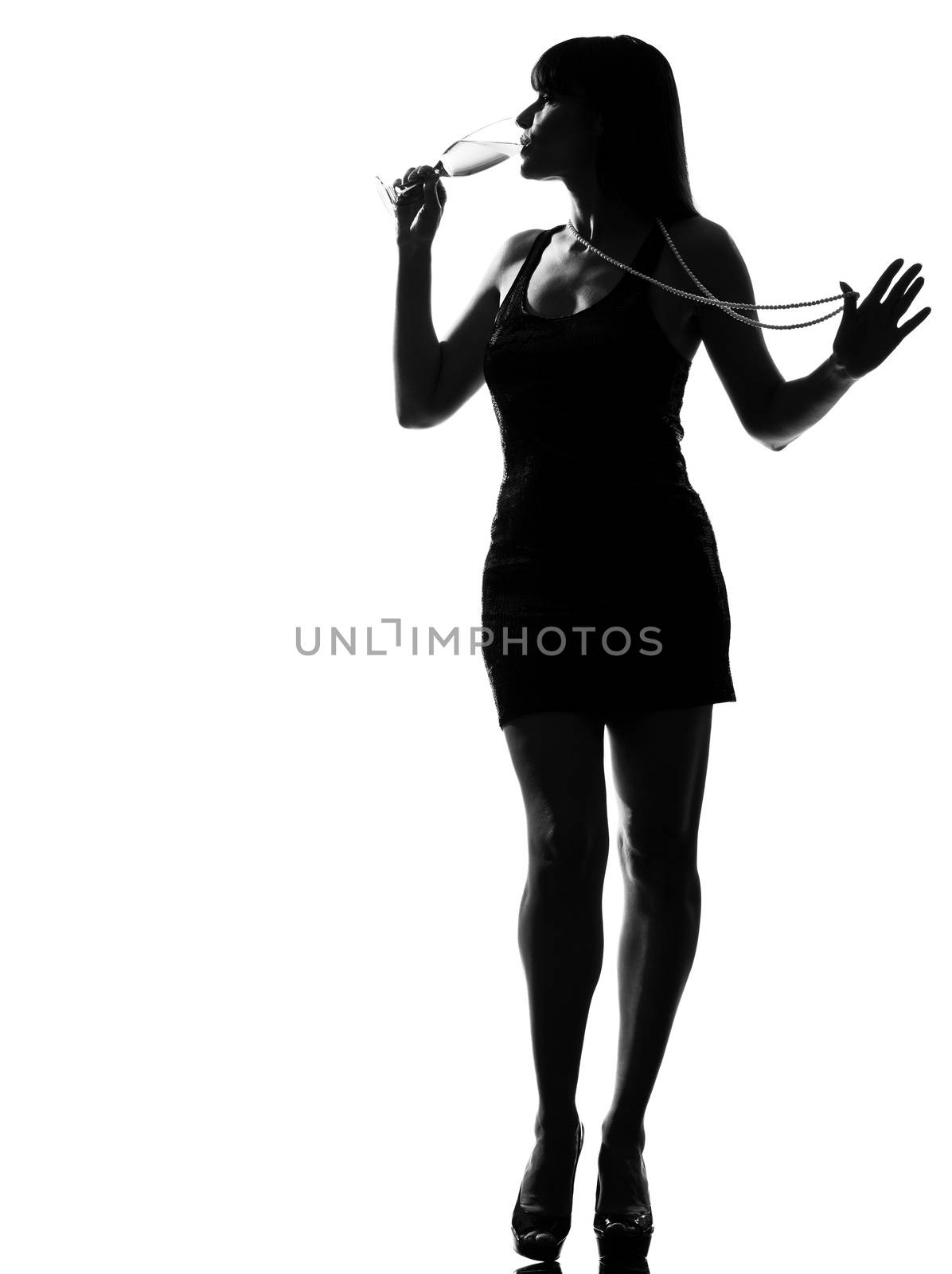 stylish silhouette caucasian beautiful woman partying drinking champagne flute glass cocktail full length on studio isolated white background