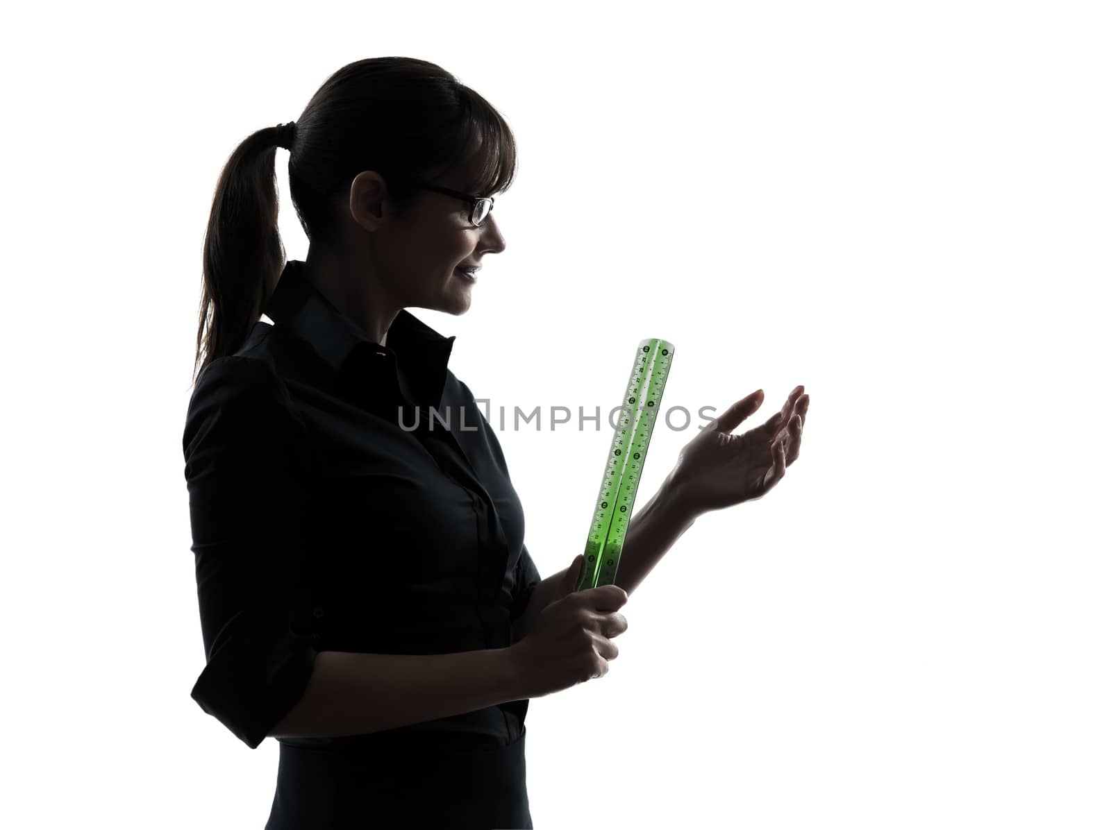 one business woman teacher holding  ruler  silhouette studio isolated on white background