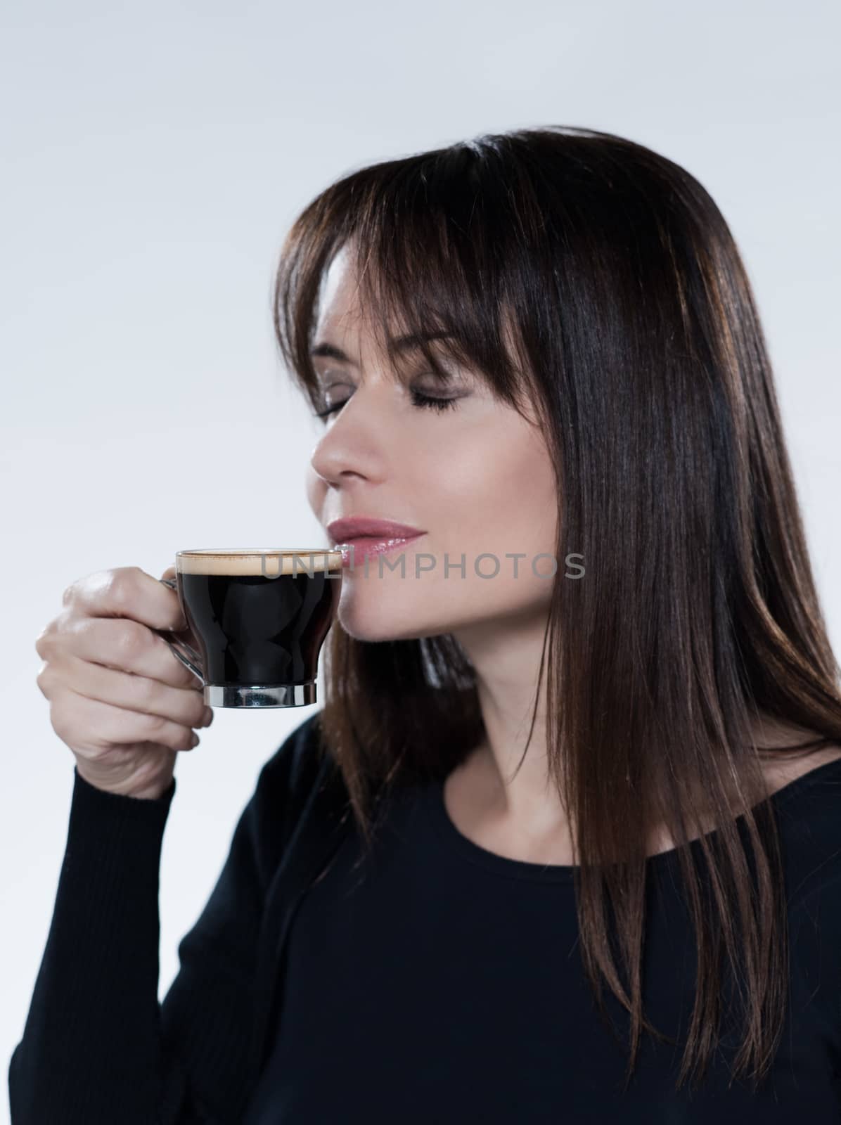 woman drinking smelling coffee by PIXSTILL
