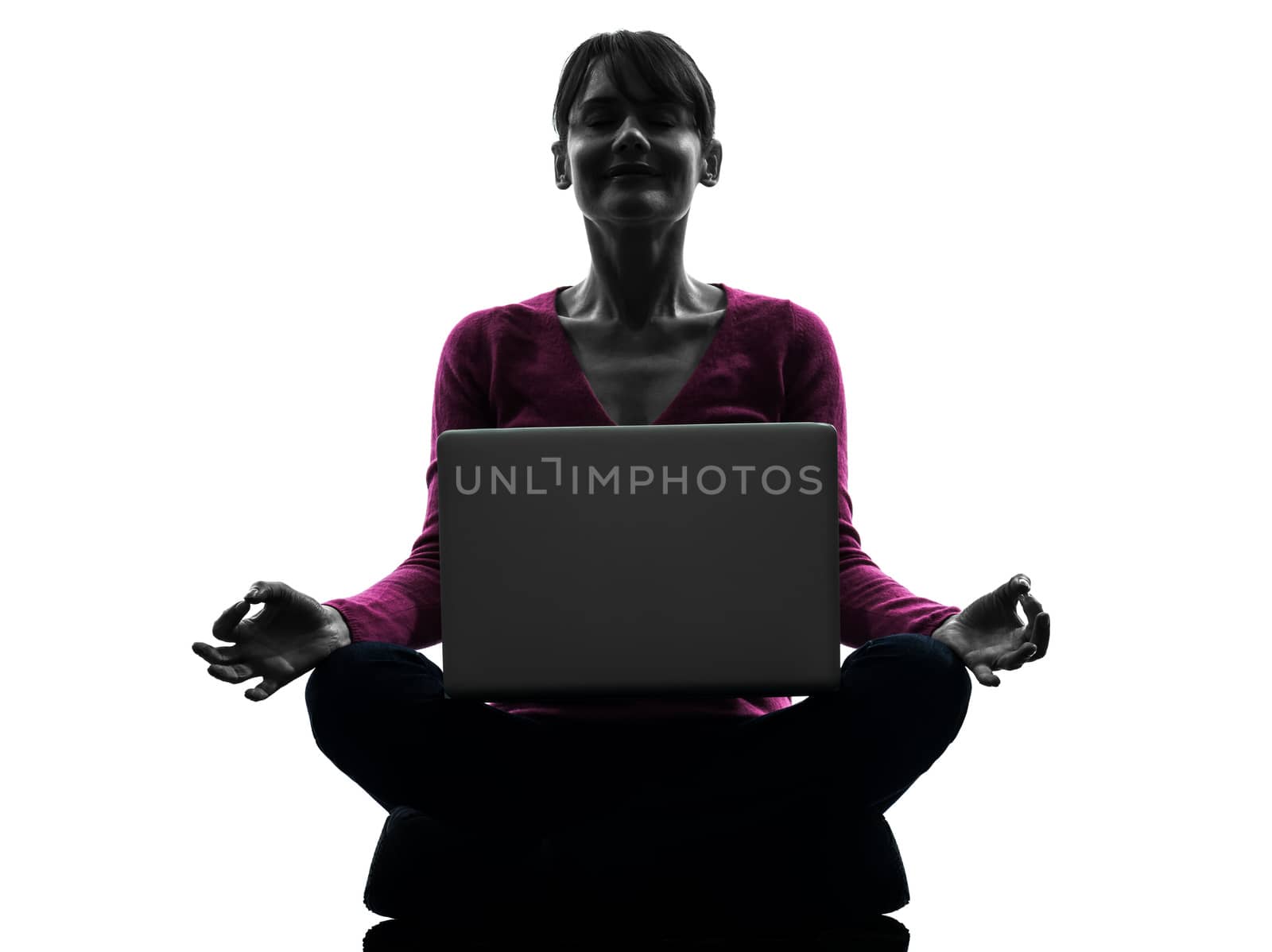 one caucasian woman lotus posture  computing laptop computer  in silhouette studio isolated on white background