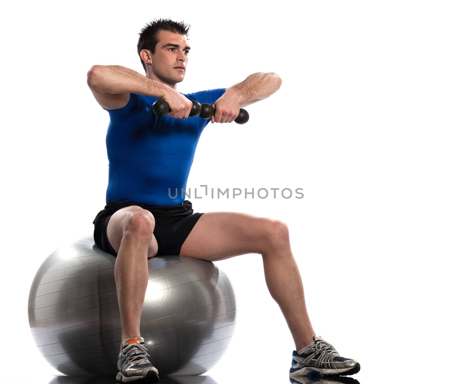 one caucasian man exercising workout weigth training sitting on fitness swiss ball full length isolated on white background