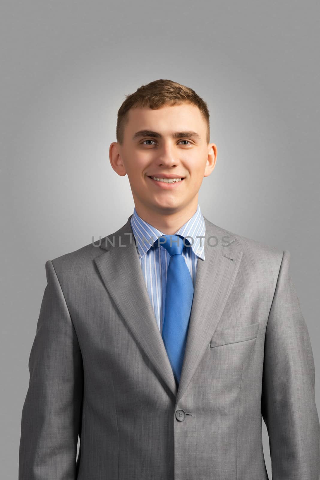 Portrait of a young businessman smiling and looking at the camera