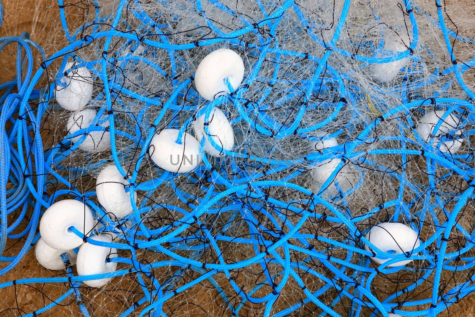 close up blue fisherman net with white buoy bouee