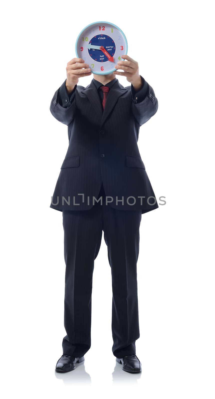 Man in suit holding clock over face isolated on white