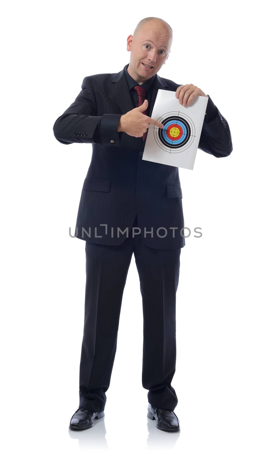 Businessman holding a target and pointing at the bullseye