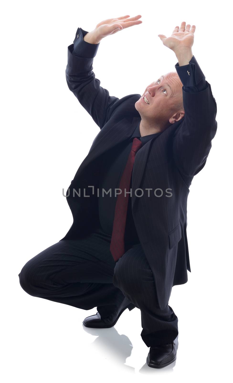 man in suit cowering isolated on white