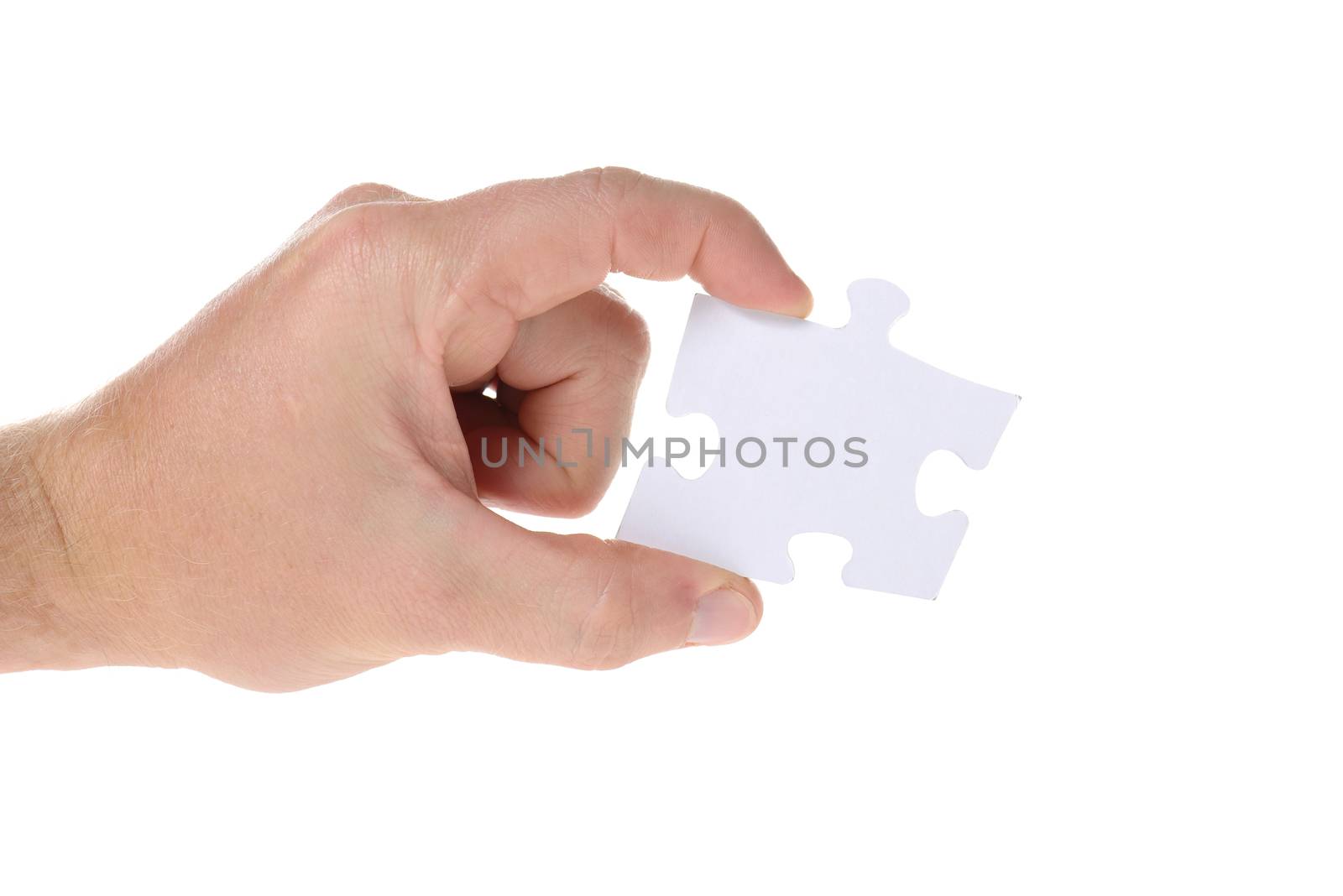 Hand hold a piece of jigsaw puzzle isolated on white