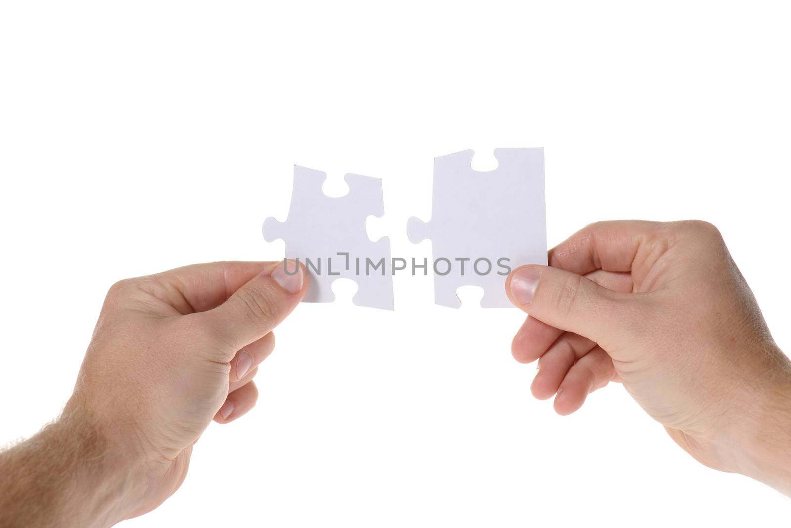 Hands with two puzzles. Isolated on white background 