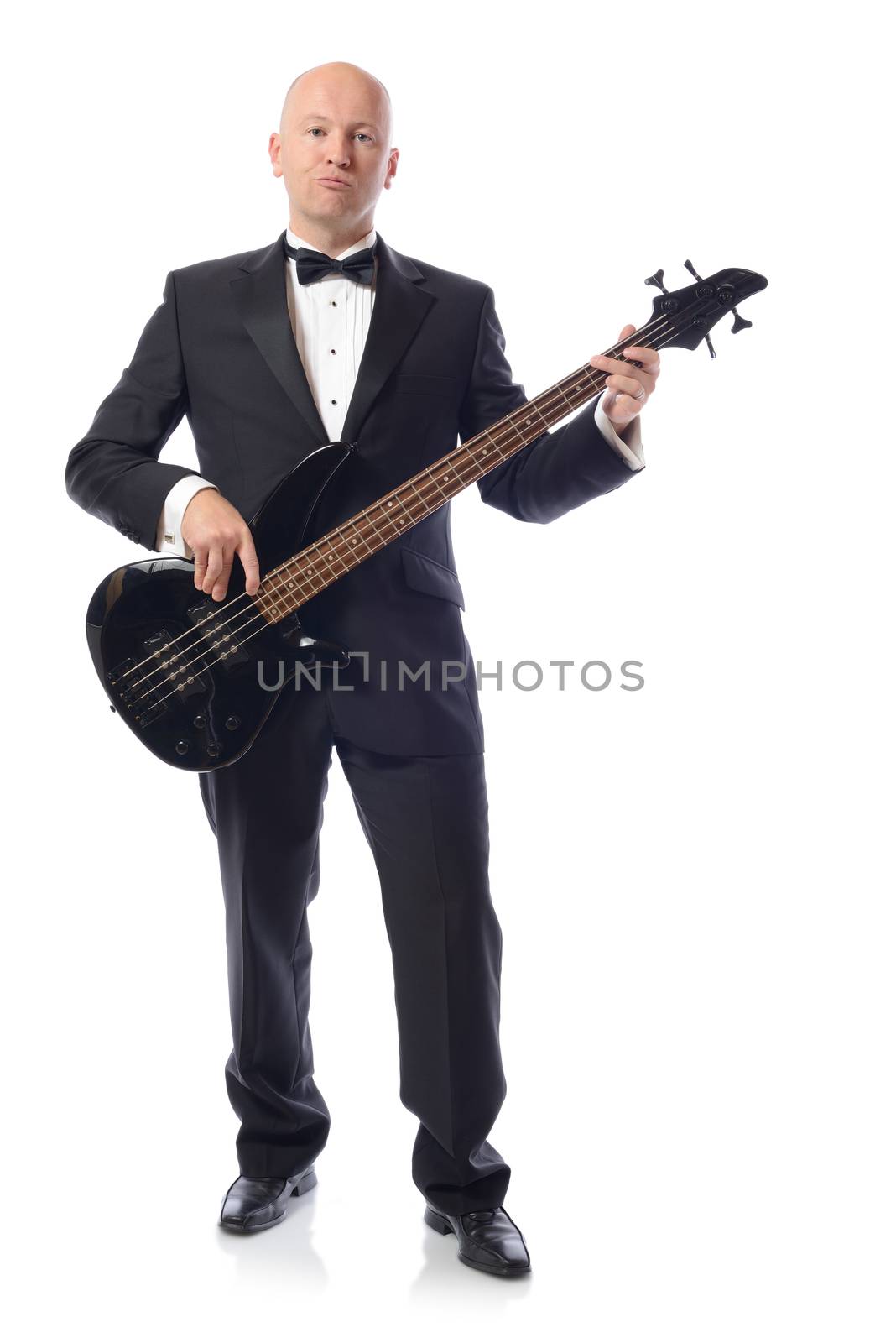 Man in a tuxedo playing bass guitar isolated on white