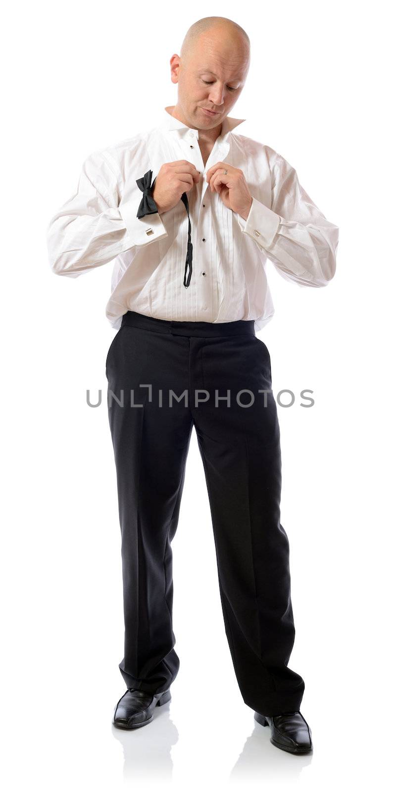 getting ready Man dressing up in formal clothing tuxedo for a party or wedding isolated on white background