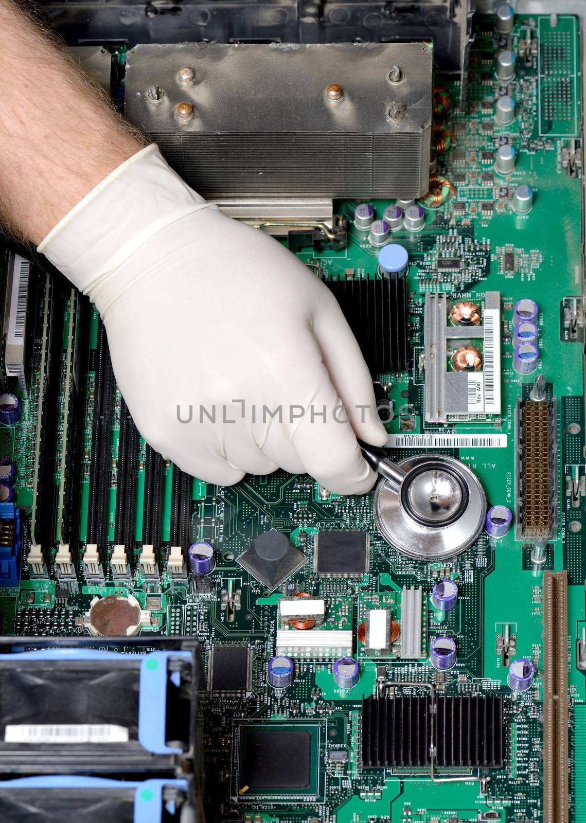 Silver stethoscope lying down on an server motherboard