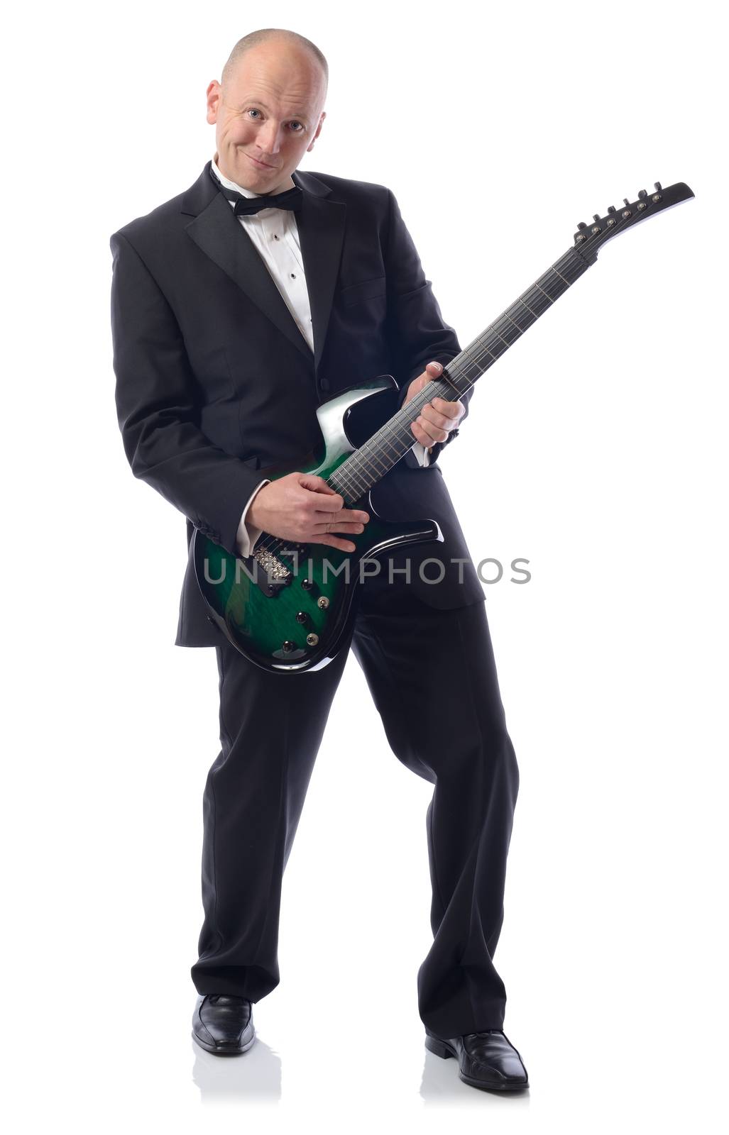 man in tuxedo playing guitar isolated in white