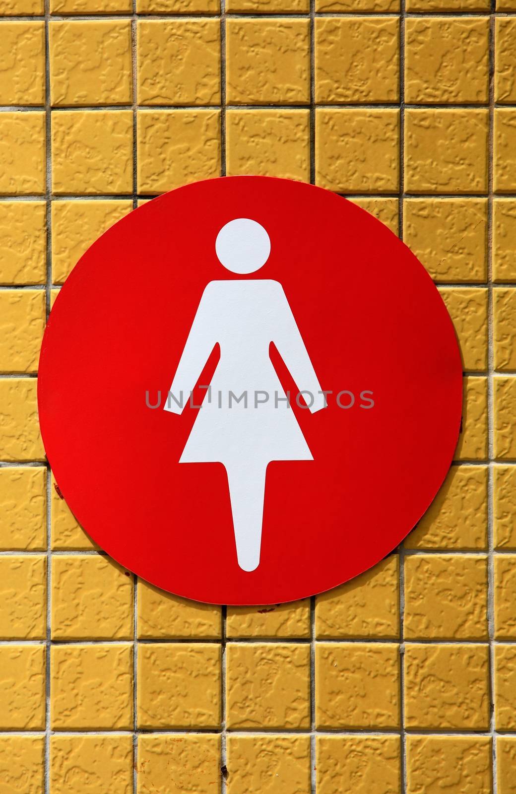women restroom signal on the yellow ceramic background