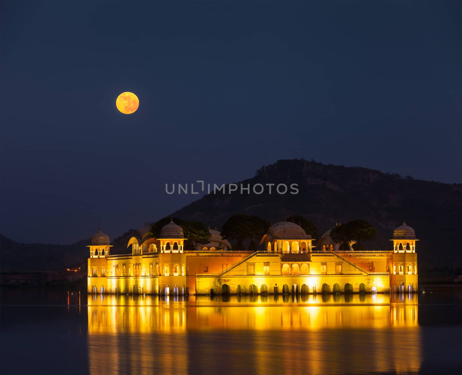 Rajasthan landmark - Jal Mahal (Water Palace) on Man Sagar Lake at night in twilight.  Jaipur, Rajasthan, India