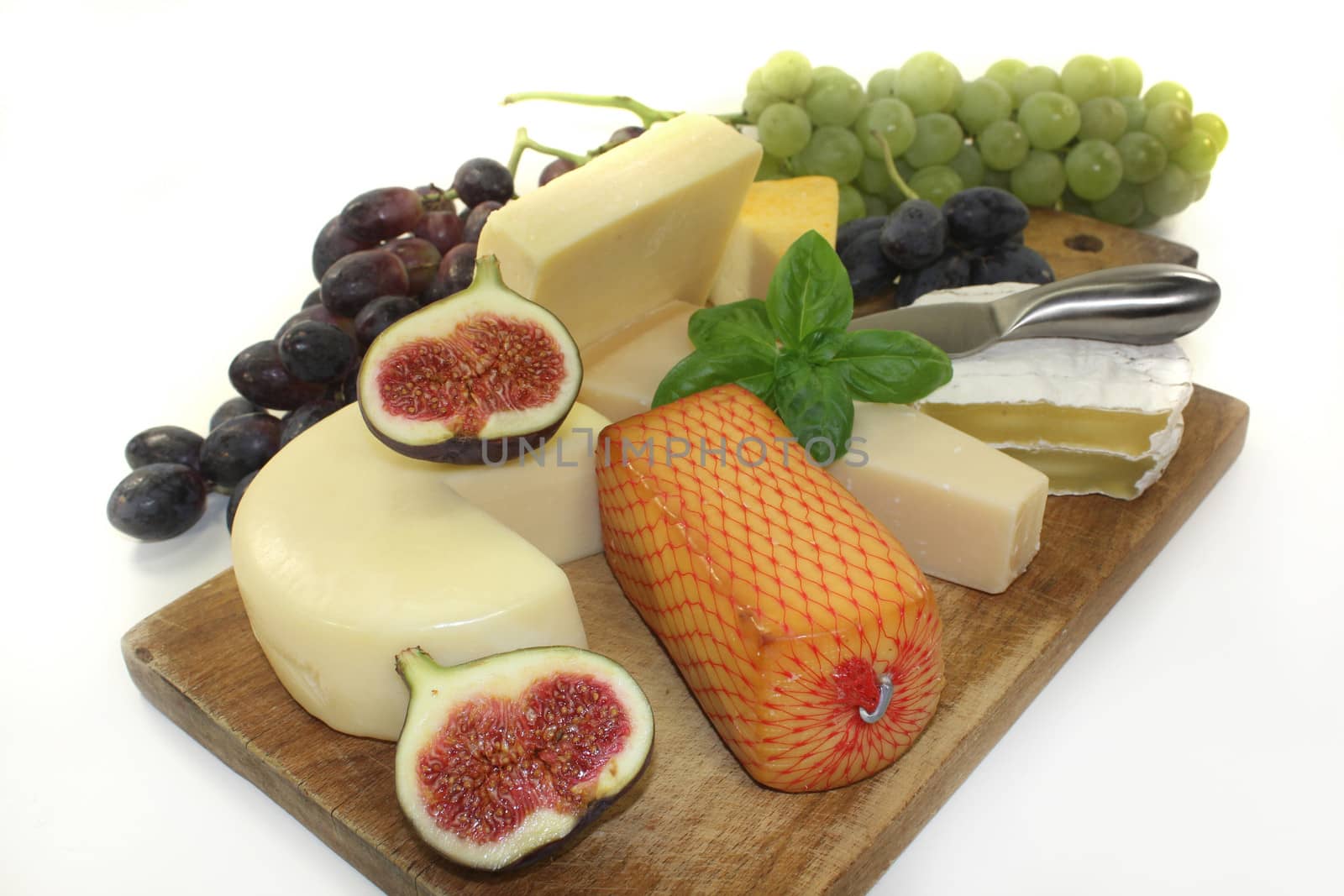 different types of cheese on a wooden board
