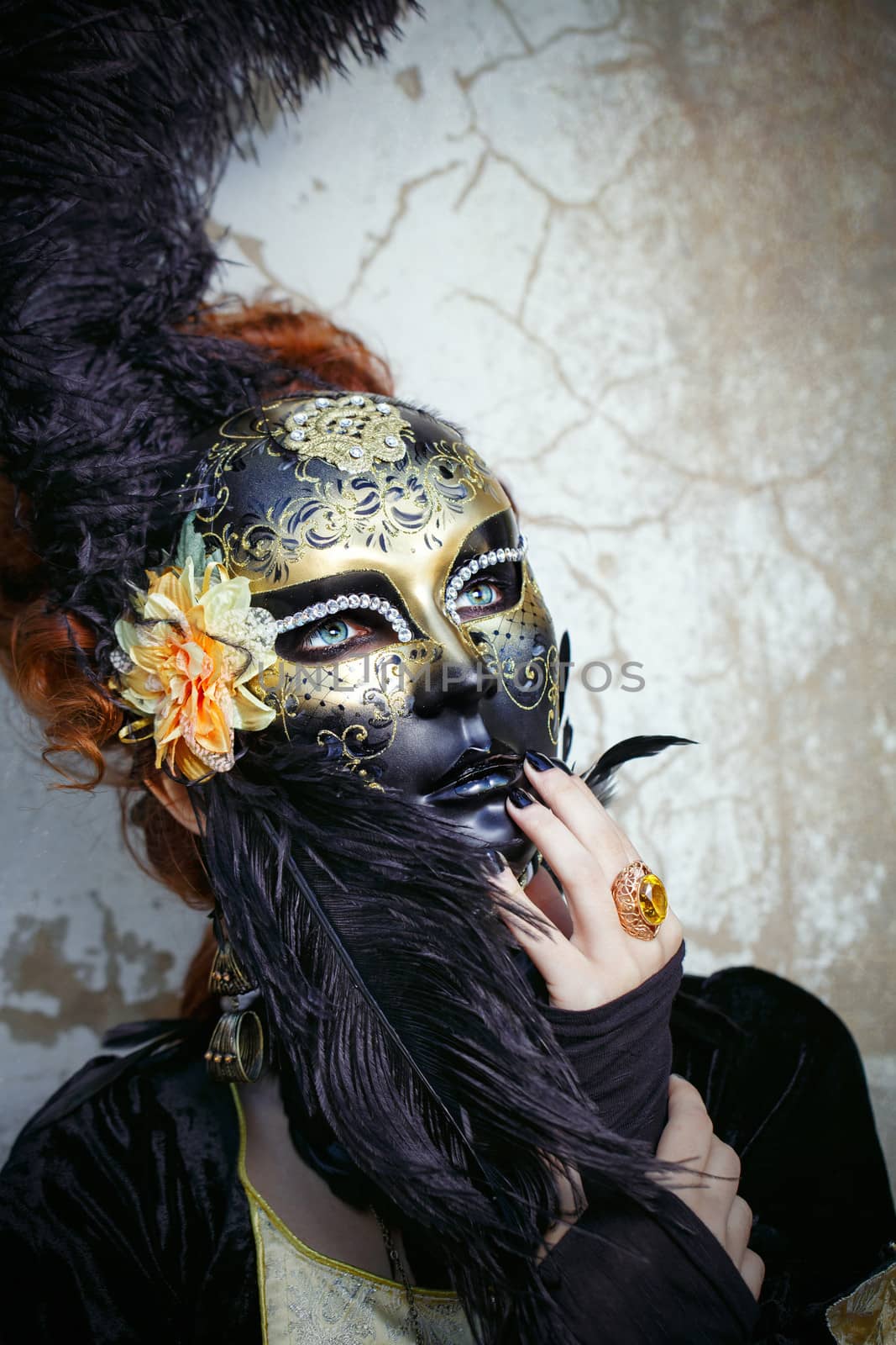 Close-up portrait of red-haired lady in a mask shot in the street