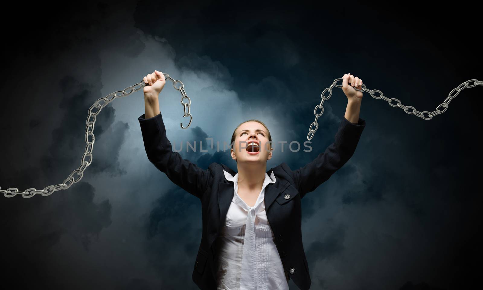 Image of businesswoman in anger breaking metal chain