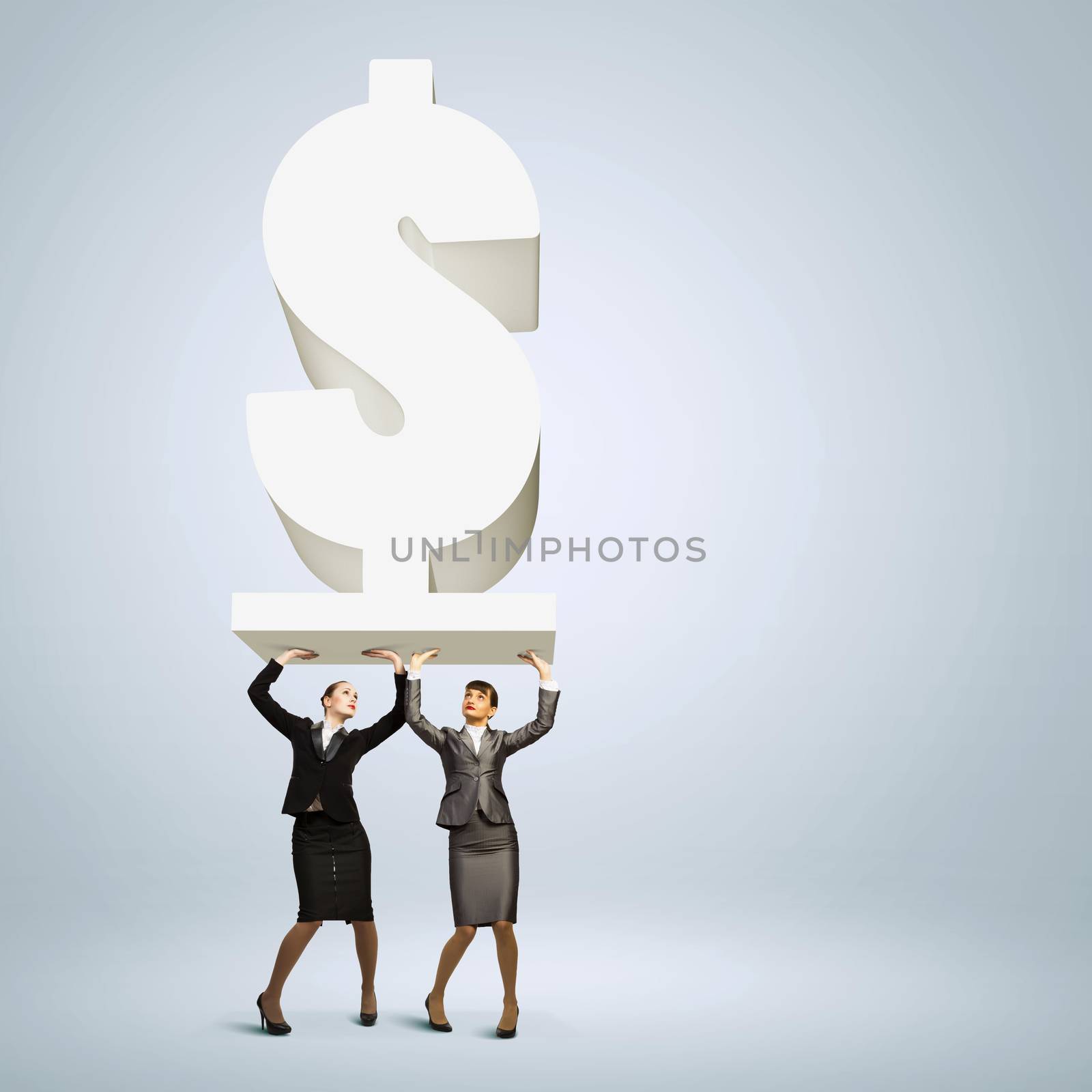 Image of two businesswomen holding dollar sign above head