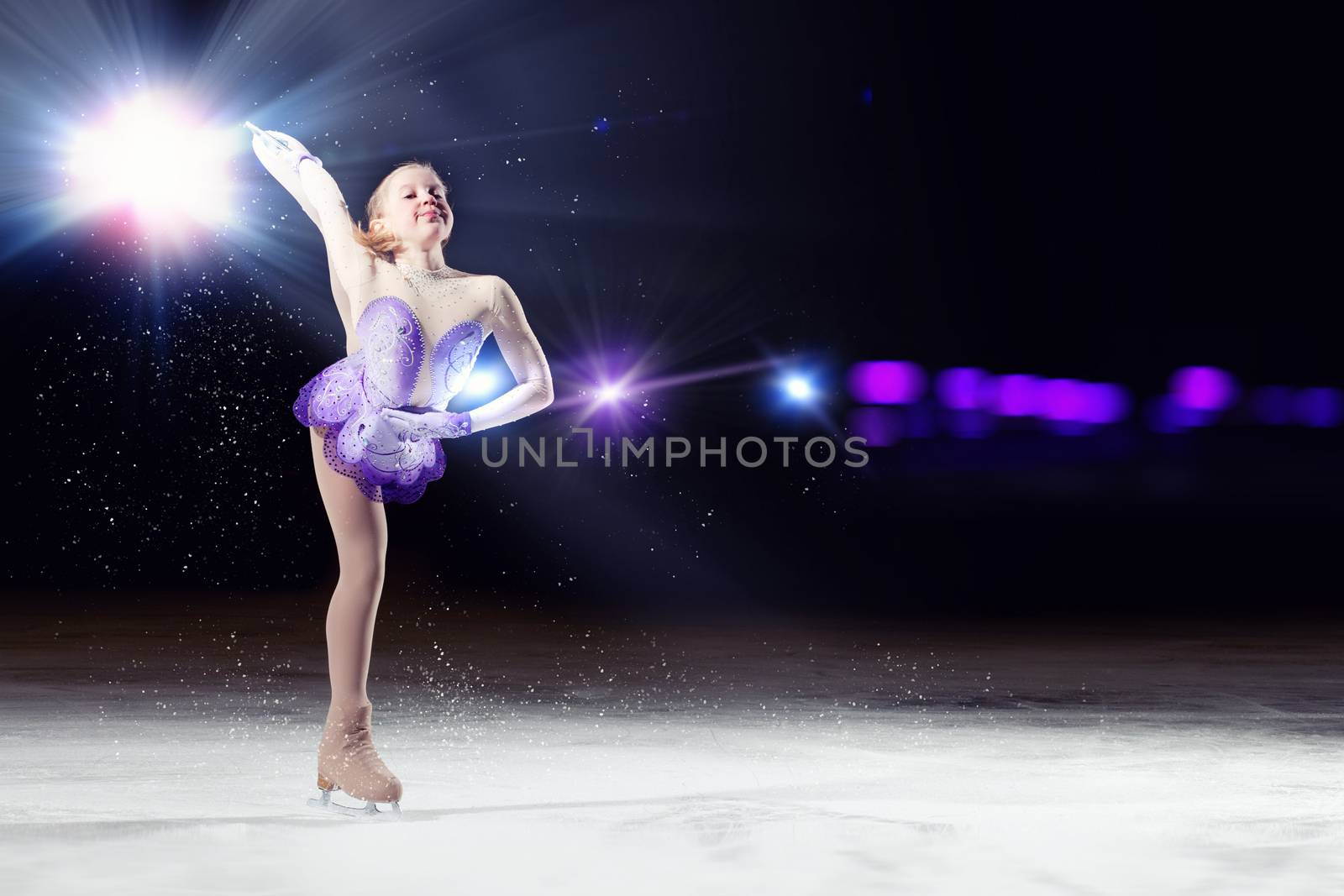 Little girl figure skating at sports arena