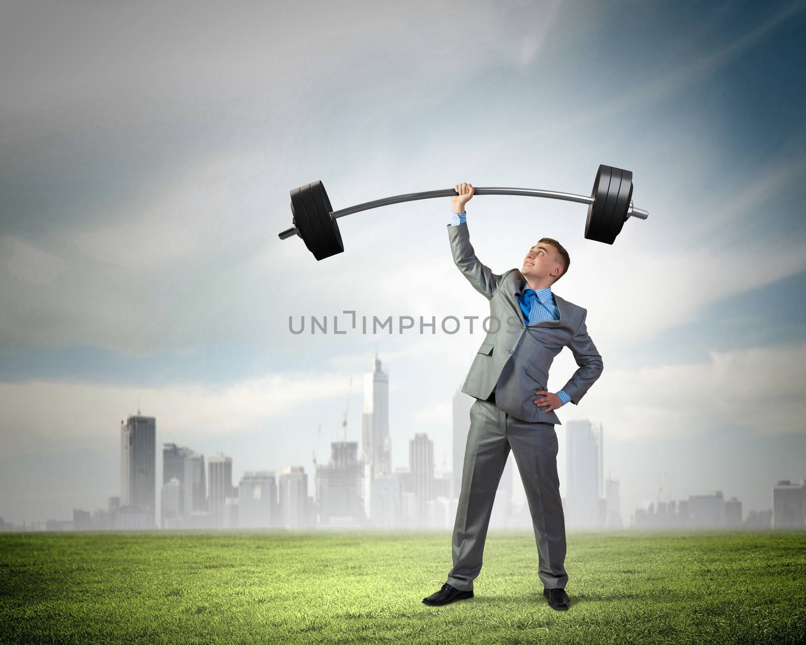 Image of strong businessman lifting barbell above head with one hand