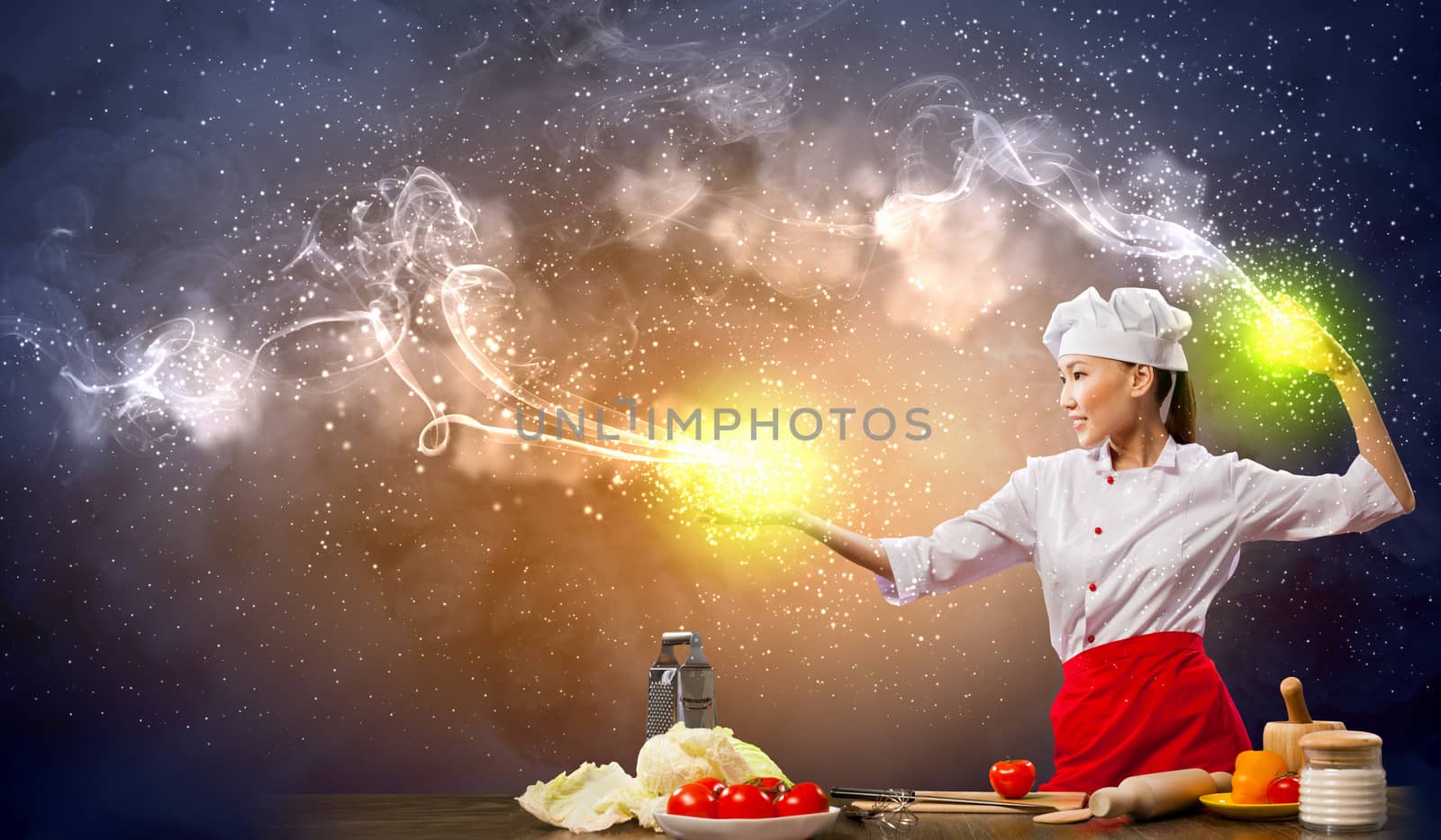 Asian female cooking with magic against color background