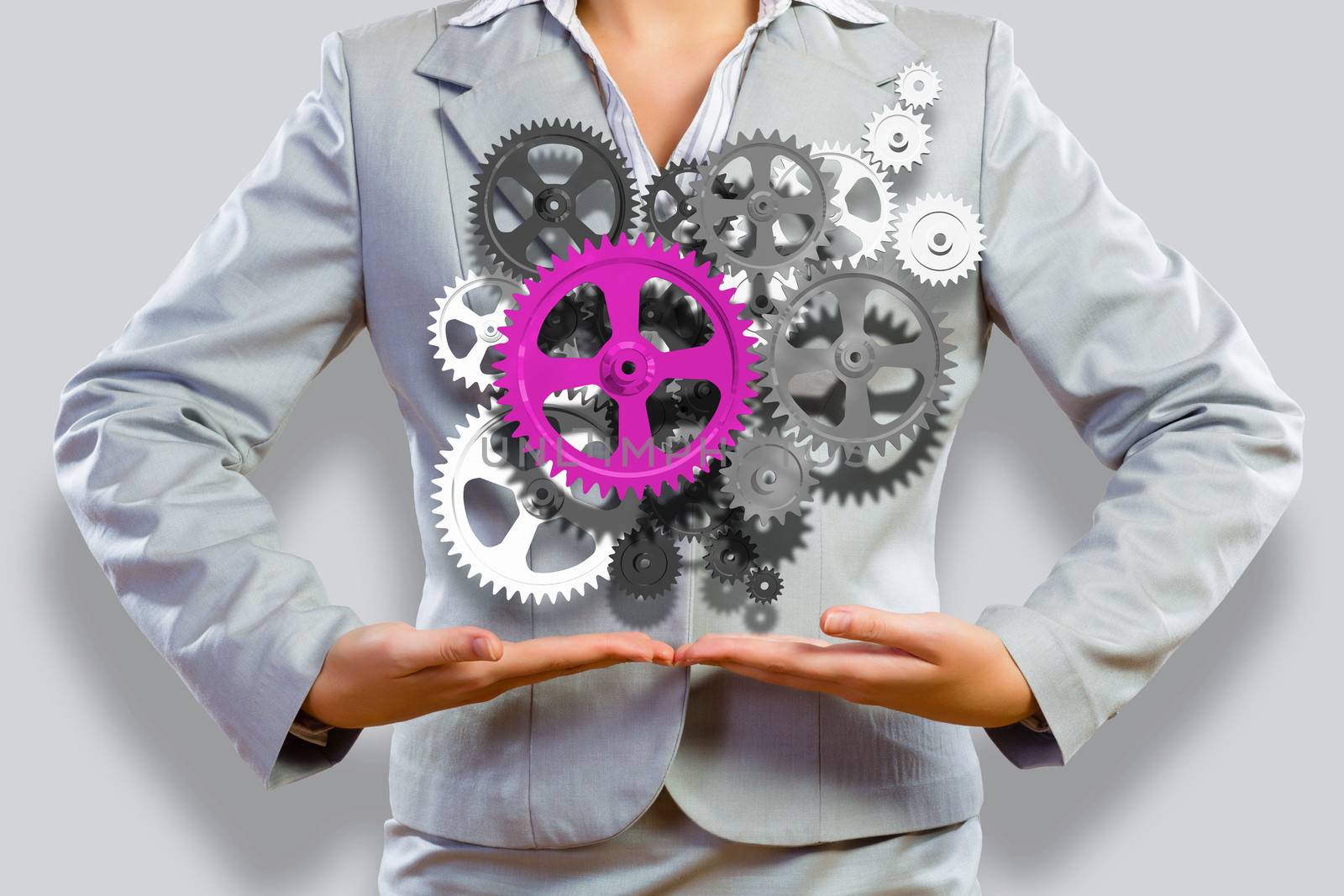 Close up image of businesswoman holding gears in hands