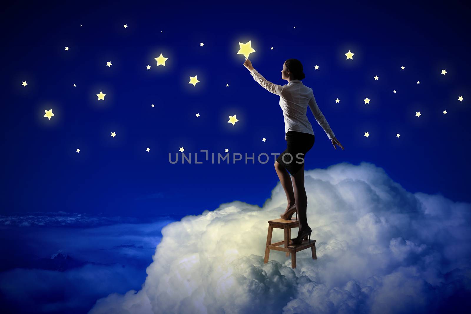 Image of young woman lighting stars in night sky