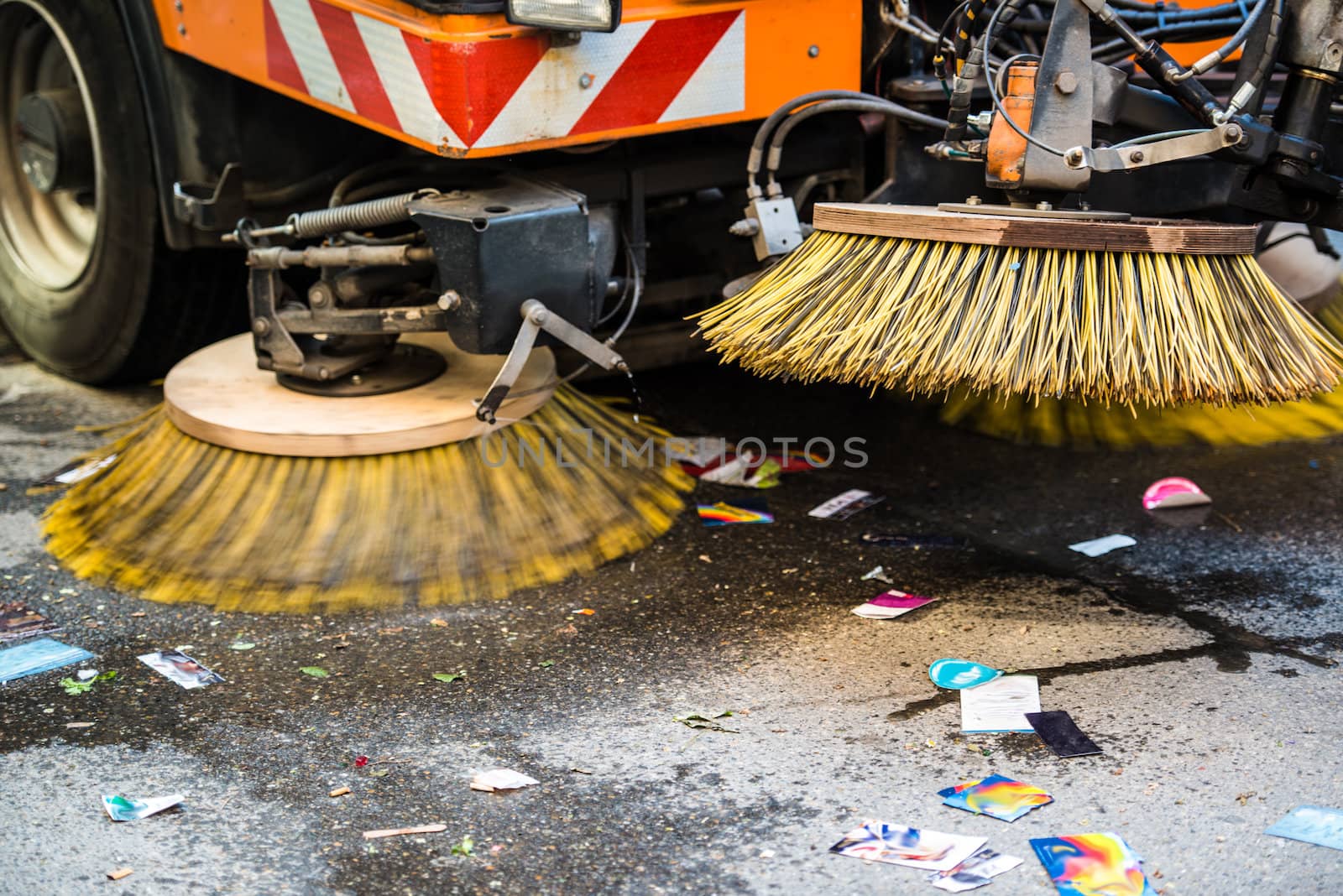 Detail of a road sweeper cleaning the streets after a parade