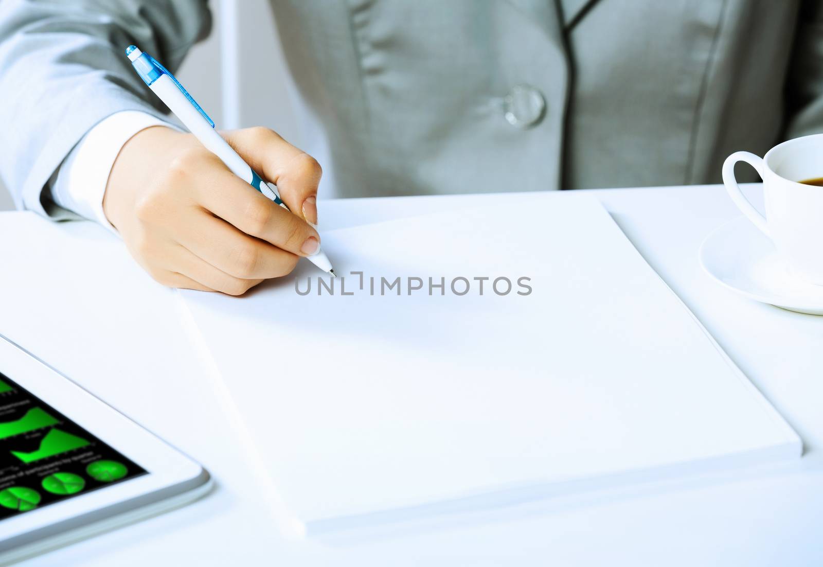 Image of businesswoman sitting at table and drawing sketch