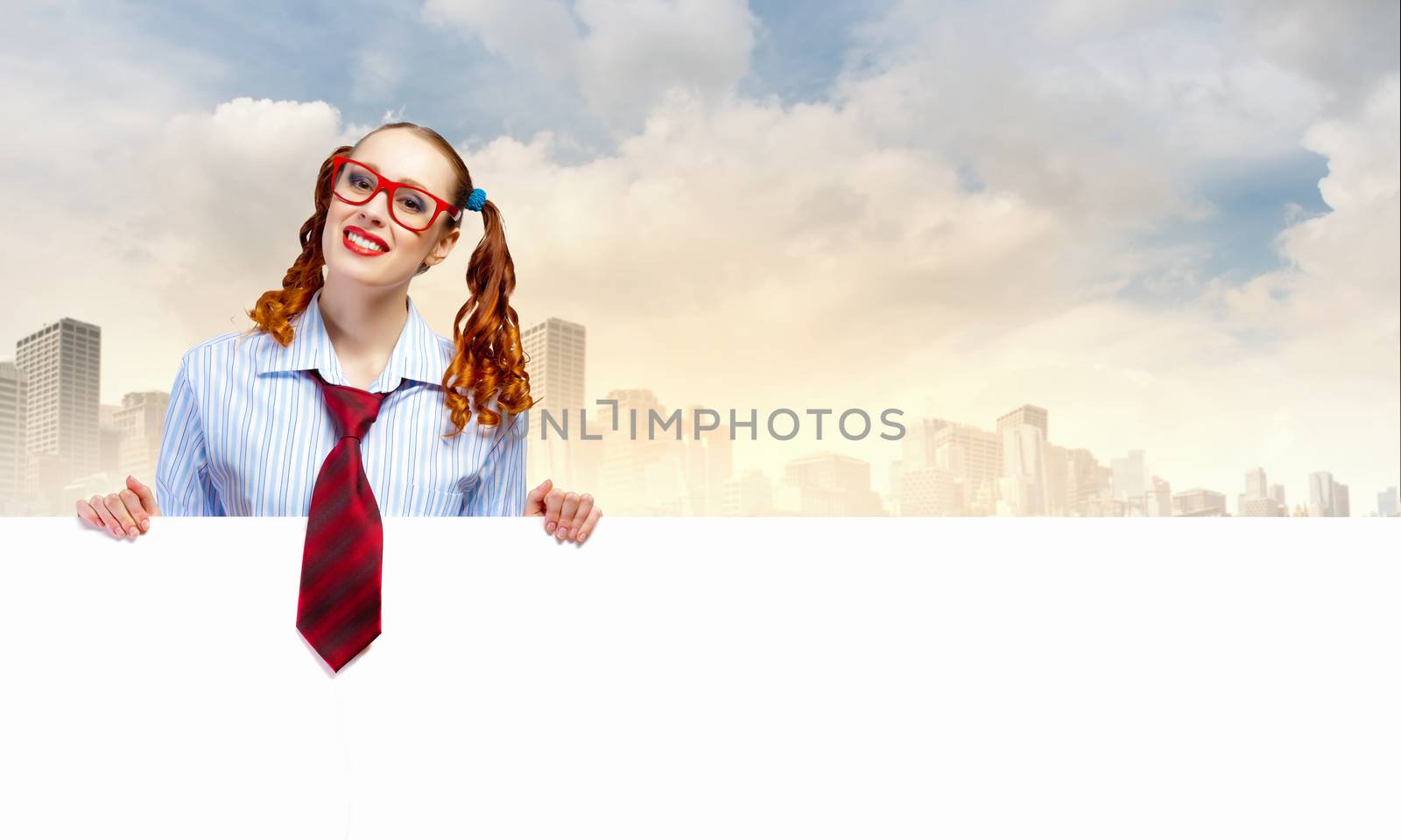 Young woman holding a blank white billboard