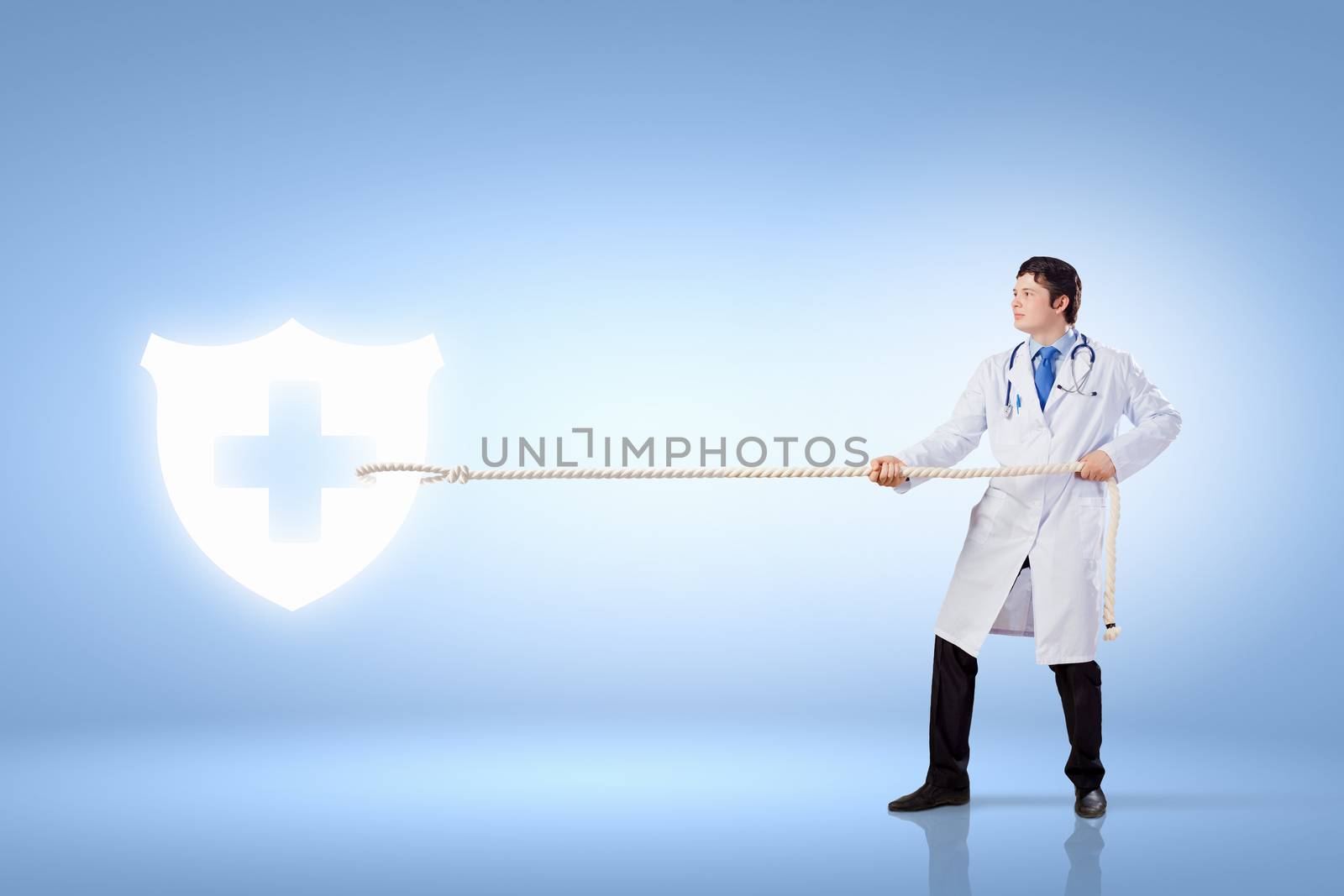 Image of male doctor pulling health sign with rope