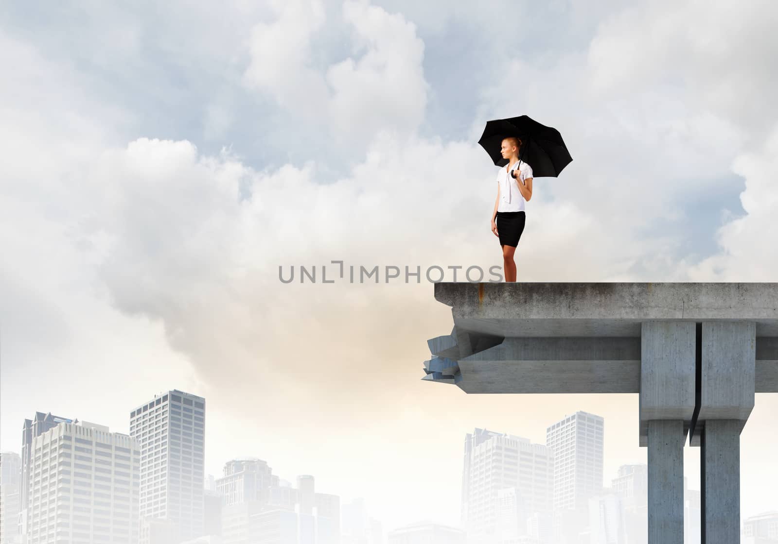 Image of businesswoman standing at the edge of bridge. Risk concept