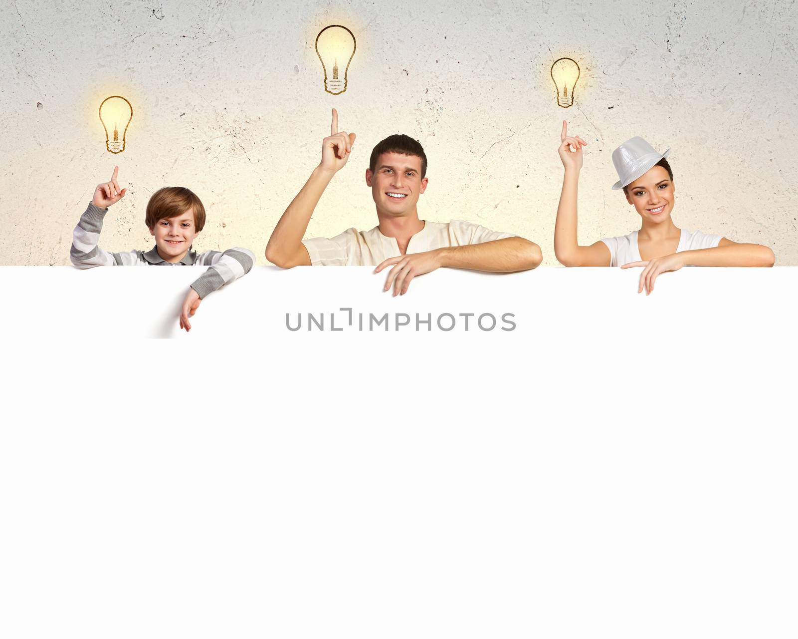 Happy young family with blank banner by sergey_nivens