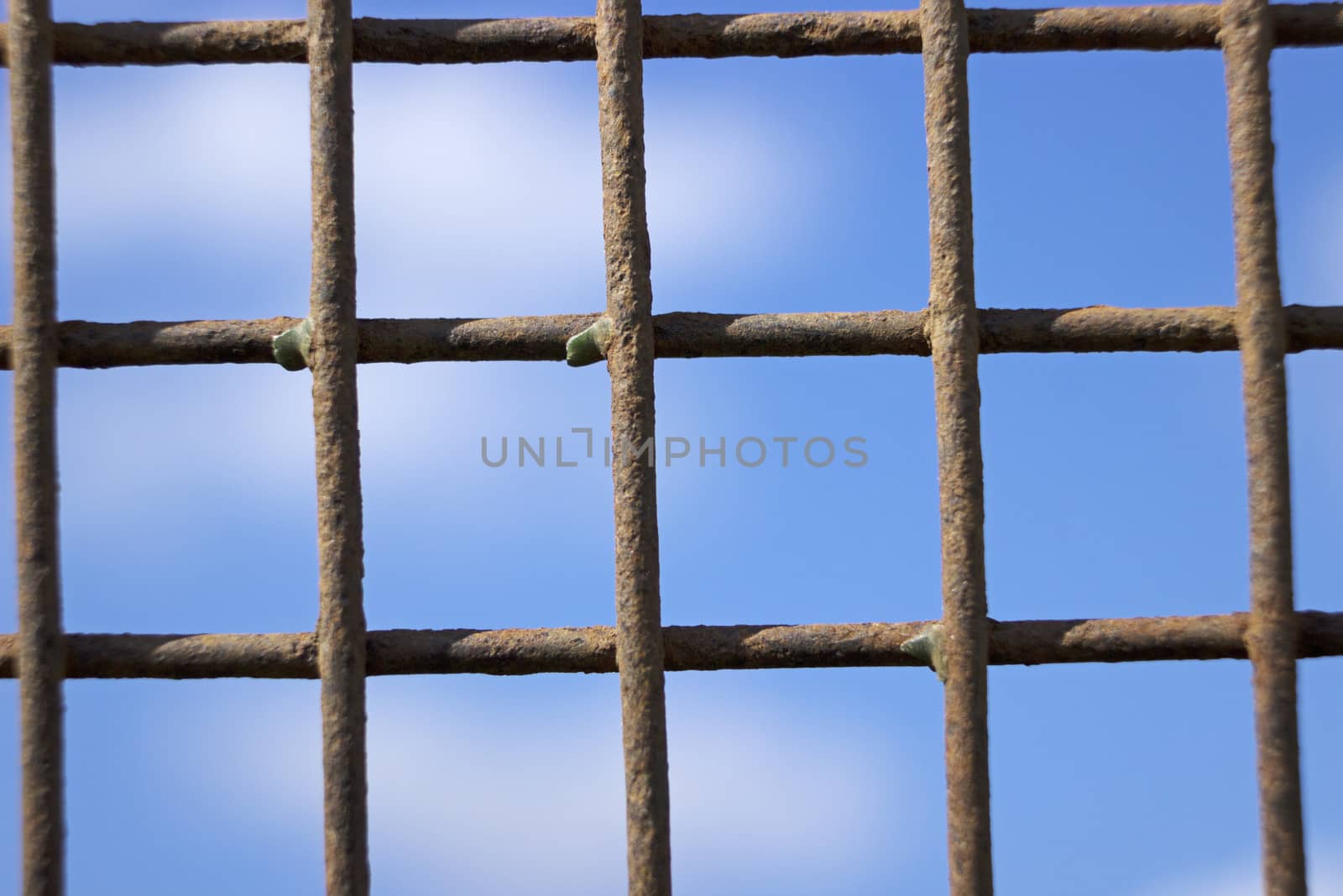 Rusty iron lattice against the blue sky