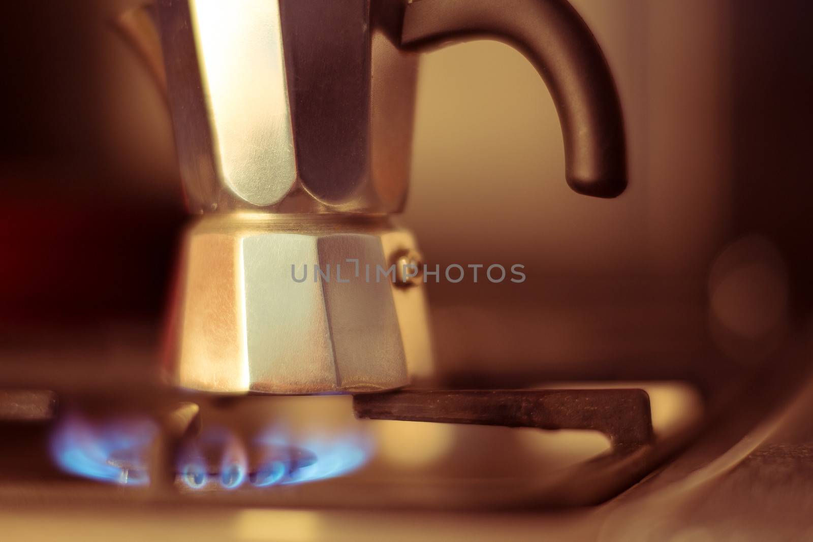 Italian coffee maker on stove, artistic photo with shallow depth of field 